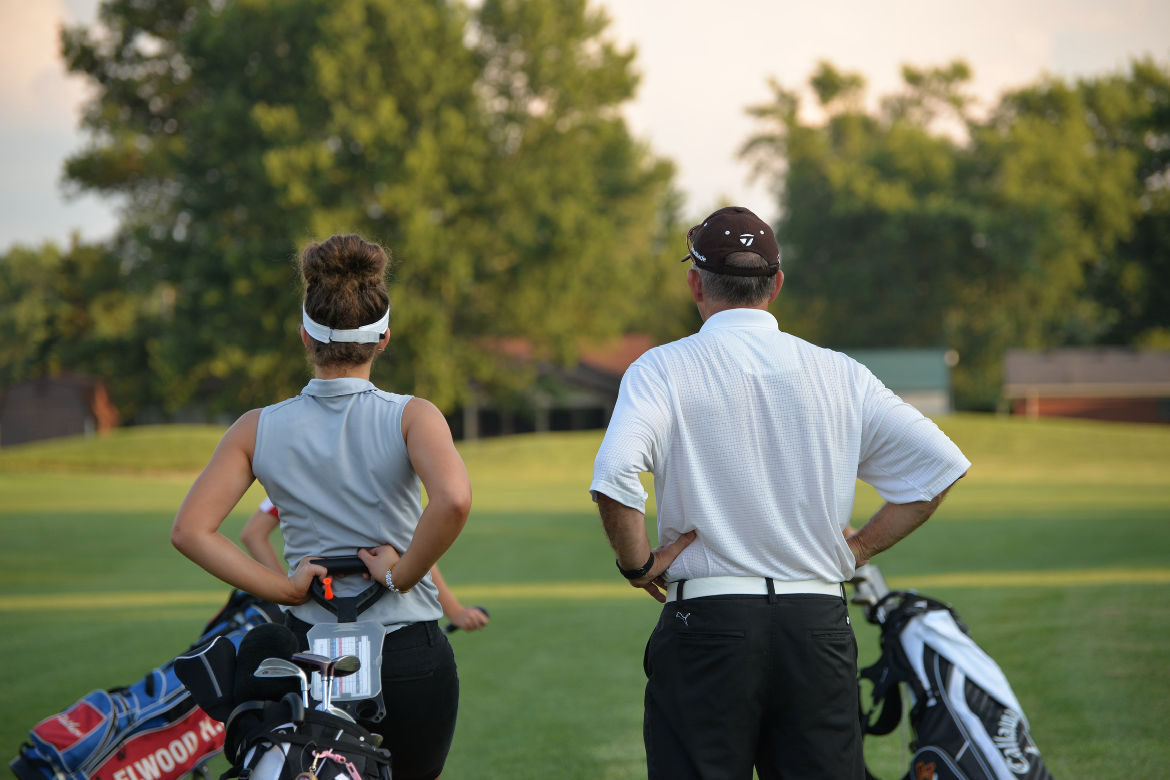 Caddying for his granddaughter.
